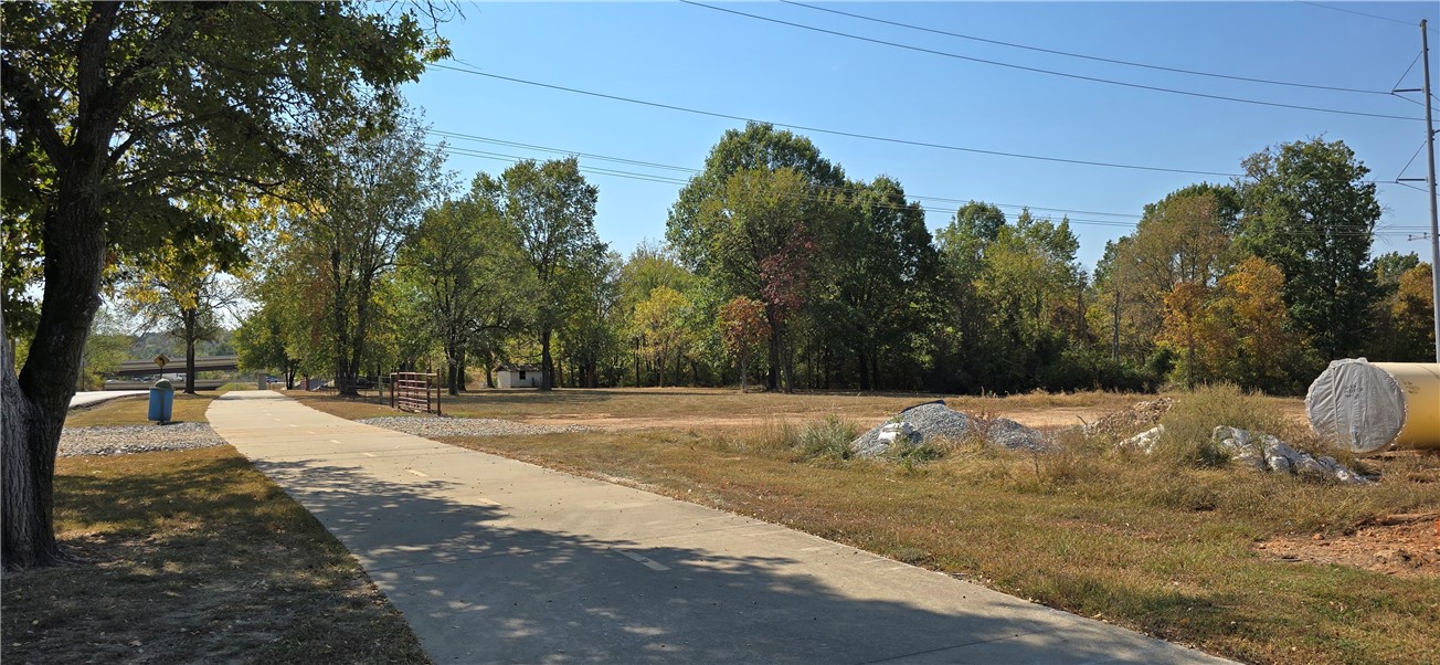 Beautiful Property just off I -49. Close to shopping and restaurants. Perfect commercial Land. Frontage touches the Razorback Greenway Biking trail. Back on the market at no fault of sellers.
