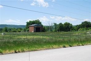 Vacant lot with 1 brick structure that is unused.   Lot is fenced and has been used as outdoor soccer field by church league. Lot is level with all city utilities available at street. Ready for your new business or hold for future development. Bypass US 62 southern option will put this property between existing US 62 and new bypass for easy access to you property. See MLS listing #
