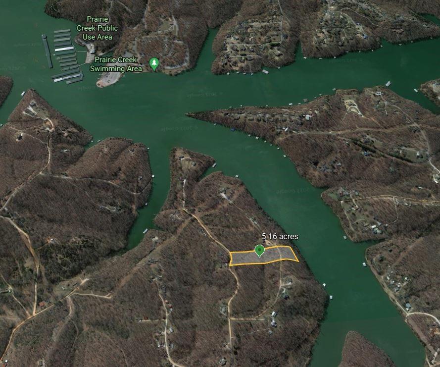 Wake up to stunning Beaver Lake views from this rare, UNRESTRICTED 5.16-acre waterfront lot near Prairie Creek Marina. Nestled in an established cove, this is the last undeveloped lot in the area and an incredible setting to build your dream lake home. Live year-round in paradise surrounded by mature trees, abundant wildlife, and peaceful lake living. The property has been surveyed, includes a topographic survey, and has been perc tested for an approximately 5,000 SF custom home. Seller's custom home plans are available for inspiration. With no restrictive covenants, you'll have the freedom to build the home you envision. The property is zoned for a boat dock if a permit can be obtained or purchased. A boat slip in a neighboring community dock could also be an option, subject to availability. Buyers should verify dock options during due diligence.
Opportunities like this rarely come along, your Beaver Lake dream starts here!

Drone photography coming 7/14