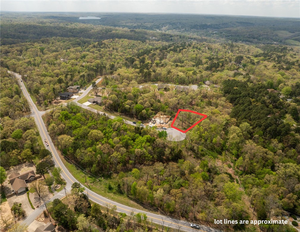 Nestled at the end of a quiet cul-de-sac in the desirable Trail Ridge Subdivision, this beautiful 0.40-acre lot offers the perfect setting to build your dream home. Enjoy the privacy and minimal traffic that come with cul-de-sac living, along with the natural beauty that Bella Vista is known for.  Located within the highly sought-after Bentonville School District, this property combines convenience with lifestyle. All public utilities are available, including high-speed internet—ideal for today’s connected living. Outdoor enthusiasts will love the easy access to nearby trails, perfect for walking, biking, and exploring the scenic surroundings. With a minimum build requirement of 1,950 square feet, this lot ensures a community of incredible homes, allowing you to bring your own vision to life.