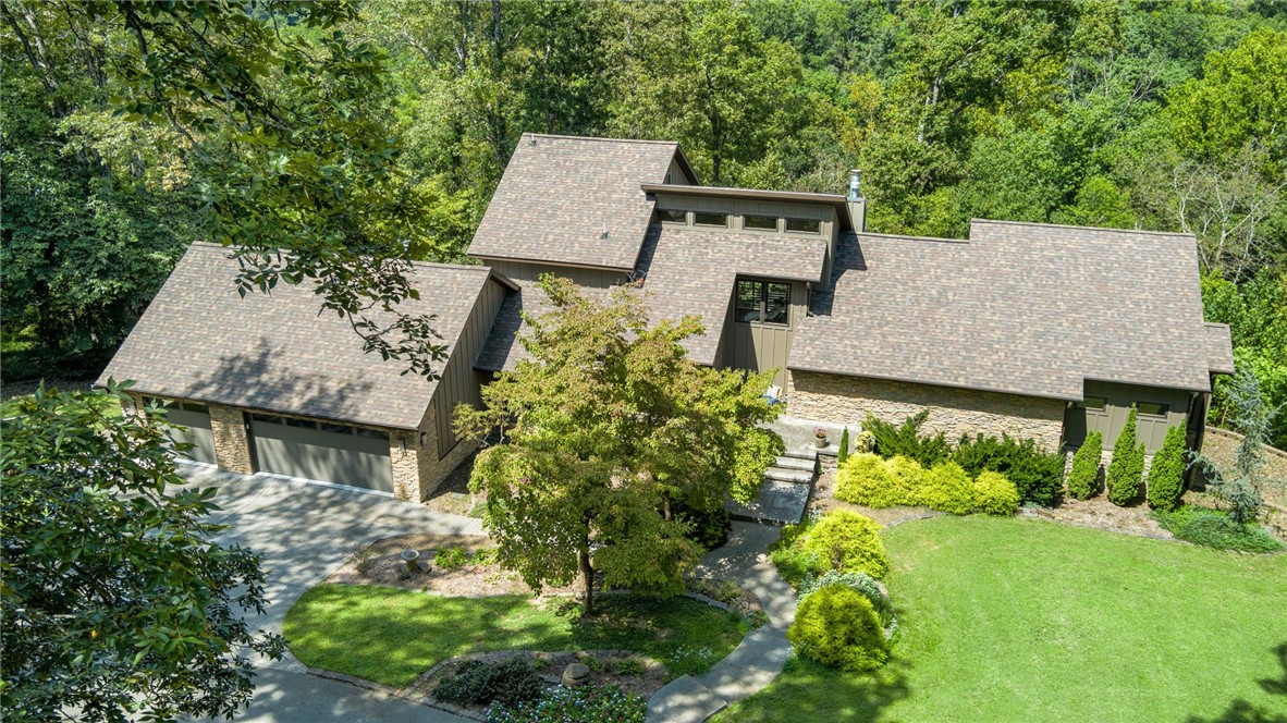 Secluded behind a gated drive on 28 acres, this rare estate offers an intimate retreat minutes from DT Bentonville. Rebuilt in 2017, the primary home and guesthouse harmonize modern architectural restraint, minimalist aesthetic and enduring craftsmanship. Frameless windows draw in the Ozark landscape while a pallet of maple, pine, and quartz provide warmth and aesthetic harmony. Five fireplaces anchor the ambiance throughout the primary home and the guesthouse. The main-level primary suite is a sanctuary featuring radiant heat and a Hinoki Cypress soaking tub. The primary residence also contains thoughtful amenities:  library, second living area, safe room and gym.  The 1BR guesthouse is accompanied by an in-ground pool. The estate includes an 1800sf workshop w/ a 1BR apartment, a 3-stall horse barn w/ corral and McKissic Creek winds through the estate's bottomland.  Located close to Coler Mtn. Bike Preserve, this uncommon and beautiful estate brings the natural world, modern livability and connectivity together.