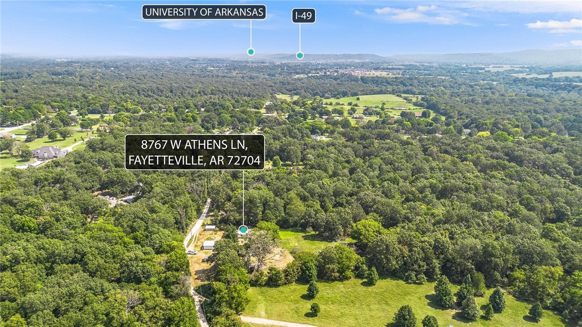 VALUE IS IN LAND. -This flat and ready to be built on land off Wedington offers secluded and peaceful country living just minutes from town—only 10 minutes to shops and dining, and about 20–25 minutes to downtown and the University of Arkansas. The manufactured home has zero value—offering a detached 10x20 garage, storage shed, woodshed, well house, carport, plus additional storage buildings (one 10x8 and one 20x20); nearby you’ll find Kessler Mountain trails, Lake Fayetteville, and the Botanical Garden of the Ozarks. Come put your vision to work, and make this one yours!