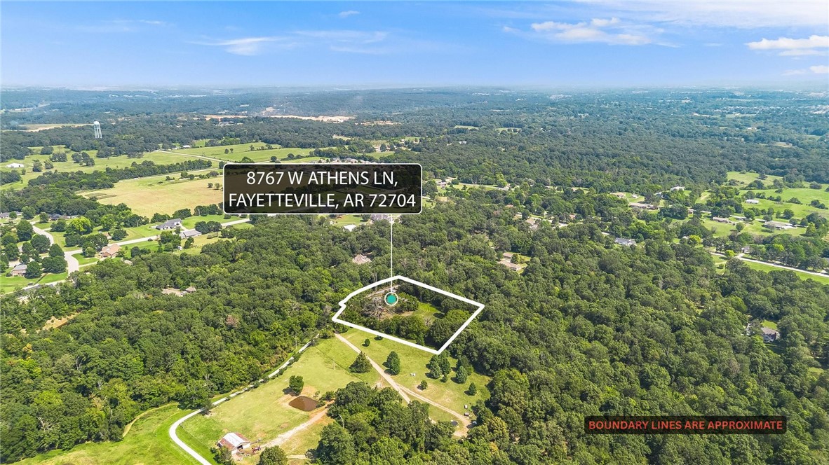 VALUE IS IN LAND. -This flat and ready to be built on land off Wedington offers secluded and peaceful country living just minutes from town—only 10 minutes to shops and dining, and about 20–25 minutes to downtown and the University of Arkansas. The manufactured home has zero value—offering a detached 10x20 garage, storage shed, woodshed, well house, carport, plus additional storage buildings (one 10x8 and one 20x20); nearby you’ll find Kessler Mountain trails, Lake Fayetteville, and the Botanical Garden of the Ozarks. Come put your vision to work, and make this one yours!