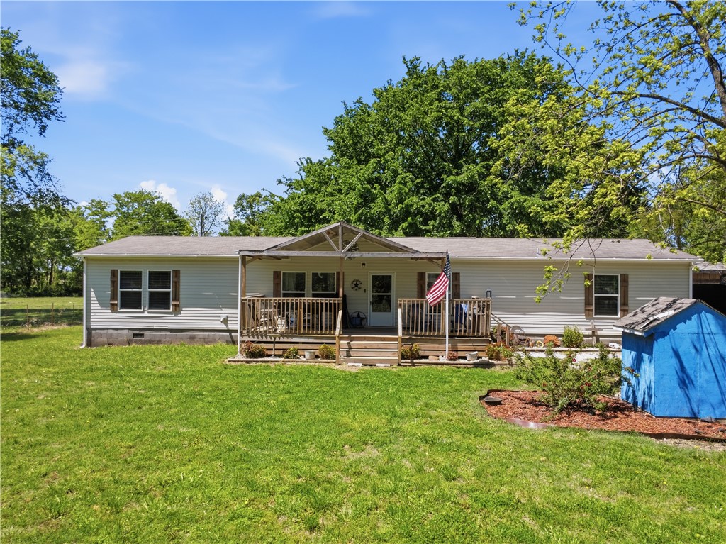 This spacious 4-bedroom, 2-bath manufactured home with a large shop is situated at the end of a private drive,on approximately 11 acres.  It offers both privacy and charm. The property combines comfort, functionality, and convenience, allowing you to enjoy peaceful country living just a short drive from town.