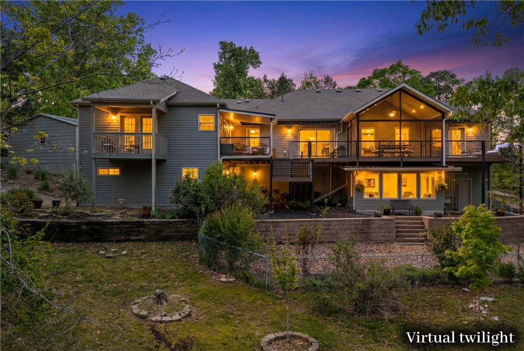 Welcome to your Beaver Lake retreat! Tucked on a quiet cul-de-sac with 5.01 acres of privacy & a seasonal lake view. The golf cart conveys & you can be at your boat slip in minutes. The semi-open layout connects all spaces, creating a functional flow. Large windows bring in natural light for an airy feel. The kitchen overlooks a spacious deck. The main level features two primary suites. The second offers its own living area, kitchenette, full bath, & private deck ideal for guests, multi-generational living, or rental potential. A finished bonus room with a full bath adds flexibility for a game room or guest space (exterior access). There’s also a separate exterior-entry bonus area for a gym, media room, or creative space. Equipped with a whole-home Generac generator. Buildable lots next door & across the street offer added opportunity. Whether you’re looking for a full-time home, weekend escape, or investment, this property offers versatility. Additional boat slip & 2.60 acres across the street also available.