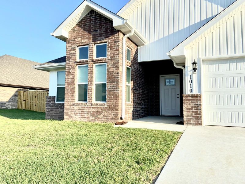 Welcome to this newer construction home in the desirable Pines at Orchard Park community in Bentonville. Built in 2023, this well-designed single-story residence offers 3 bedrooms and 2 bathrooms, featuring an open-concept layout ideal for both everyday living and entertaining. The spacious kitchen includes ample cabinetry, double pantries, and bar seating, flowing seamlessly into the main living area with elevated ceilings. The primary suite is thoughtfully designed with dual vanities, a walk-in closet, and convenient access from the utility room. Enjoy outdoor living on the covered back patio overlooking a private backyard. Situated in a growing Northwest Arkansas corridor, the home provides quick access to major employers including Walmart HQ, as well as nearby shopping, dining, and recreation. Residents benefit from proximity to highly rated schools such as Bentonville West High School and convenient connectivity to both Bentonville and Centerton amenities.