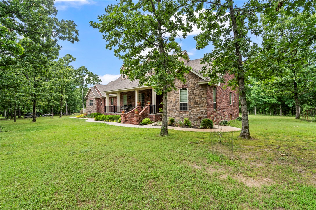 Welcome to your private retreat! This custom-built, one-owner all-brick home sits on 5 wooded acres at the end of a road, offering peace, privacy, and room to enjoy country living. Built in 2012, this 2,264 sq ft home features a split floor plan, hardwood floors, crown molding, custom cabinetry, and quality finishes throughout. The kitchen offers custom-built cabinetry, lots of extras, and a large pantry. A dedicated office could also serve as a 4th bedroom. The spacious primary suite offers a relaxing escape with a large ensuite bath. Enjoy the covered patio overlooking the wooded setting with an outdoor kitchen, perfect for entertaining or morning coffee. Outside you'll find a fenced garden area with fruit trees. There's an attached 3-car garage plus impressive 70x30 shop with storage, electricity, w/d hookups, and full bath with shower. Covered RV parking with full hookups too!
