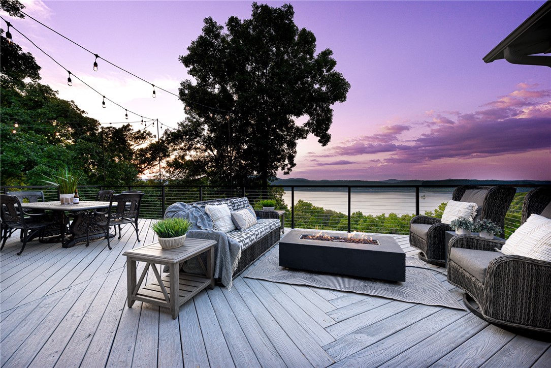 This home is the lakeside Shangri la you deserve: 5200+living SF, 3+ acres and breathtaking 20-mile lake
views overlooking the waters of Beaver Lake. Imagine sitting at the infinity edge pool or the firepit,
watching endless sunsets surrounded by nature’s beauty. The main level is an open living/dining/kitchen
area with a seamless indoor/outdoor relationship to the expansive upper deck with multiple sitting and
dining areas. The eat-in-kitchen and primary both lead out to the screened-in-porch with the same
memory-making views. The lower walk-out level, with a seamless visual relationship to the infinity edge
pool and hot tub, has a bar and oversized media/family room. You can store your ATVs, kayaks, and other
toys in the oversized lower garage. Not to be overlooked: 3rd level is a bunk room/bath that sleeps 7
people. Upper garage has HVAC. Shangri la is located 1 mile from Starkey Marina and you leased boat slip,
plus 12 miles to Downtown Eureka Springs for dinner and nightlife.