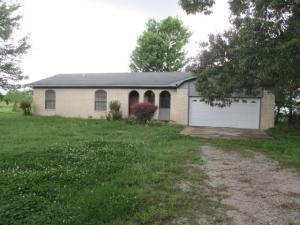 Peaceful Country Setting includes nice brick home on 2 acres approximately 10 miles from Harrison. Home is well kept, living and family rooms join to make a Great Room with fireplace and wood insert, kitchen has bar and breakfast area, includes 3 bedrooms, 2 baths and  double garage, land mostly pasture, nice trees, fenced and shed, bring a horse or few cows. Come see today!