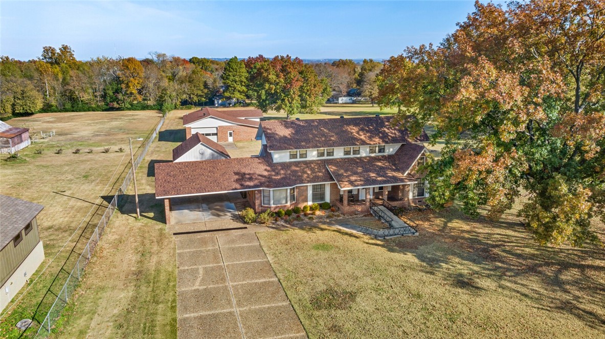 Back on market through no fault of the seller. Beautiful, well-maintained home on 4.16 flat, cleared acres just 5 minutes from UA Fort Smith! This spacious property features a HUGE upstairs bonus room spanning the length of the house, perfect for a game room, studio, or extra living space. Enjoy both formal and informal living areas, plus a large kitchen and main-level bedrooms. Washer, dryer, and refrigerator all convey. Outside, a massive 2,590 sq ft brick shop with multiple bays and a full bathroom offers endless possibilities for hobbies, storage, or work. A rare find with room to grow!  New roofs on all buildings in 2023, Water heater replaced in 2023.