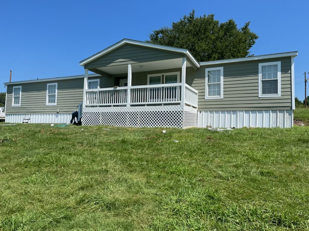 Pending with contingency. Great hobby farm property. This home has almost everything new...Roof, flooring, front porch, cover on rear porches, siding, skirting, paint inside and out. Third bathroom is jack and jill. Updated wiring and plumbing. The 2+/- fenced acres includes the pond, just right for livestock of your choice. Plenty of room for the kids to play. Ample parking for the family gatherings. Want to add another family dwelling? The east side of the property has level space for additional home, barn and/or shop.