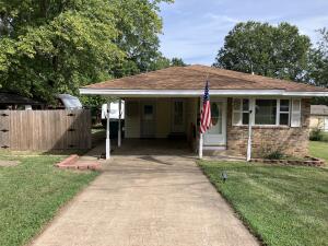 First time home buyer?  Want to downsize or secure an investment property? This 3 BR/1 BA home in a long-established Russellville subdivision checks those boxes & more.  Coziness and efficiency describe this well-maintained property & its outdoor amenities.  Since 2017, the kitchen & bathroom have been remodeled, all exterior windows replaced, & new front door added.  Encourage/start a hobby in the 16' x 24' shop w/concrete floor, electricity, ceiling fan, & overhead door.  Store lawn implements & more in the 8' x 12' shed with double door & electricity.  Find an extra detached carport & RV pad in the back.  Relax in the evening air under the pergola w/retractable screens & curtains.  Check out this property soon and you may find it's the perfect scratch for your home buying itch.
