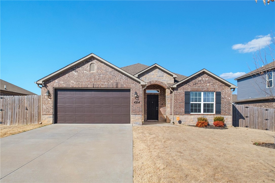 $3,000 preferred lender credit! Welcome to this inviting 4-bedroom, 2-bath home in Bentonville featuring a spacious open-concept living, dining, and kitchen area—perfect for everyday living and entertaining. The home is filled with natural light, creating a bright and welcoming atmosphere throughout. The spacious primary suite offers a relaxing retreat with an oversized walk-in closet and plenty of room to unwind. Step outside to enjoy the covered patio overlooking a huge backyard, ideal for gatherings, play, or simply enjoying the outdoors. Conveniently located with easy access to everything Bentonville has to offer, this home combines comfort, space, and functionality in a great location.