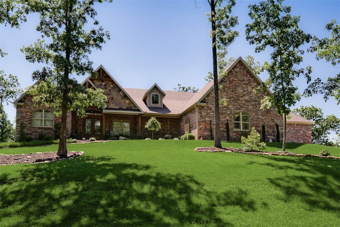 Gated Community On Beaver Lake! Come enjoy Lake life on your own private 5.5 acre estate! Only 15 minutes to downtown Rogers & 30 Minutes to Wal-mart HQ! Don't miss this absolutely beautiful custom home with its incredible design & attention to details.  The cook in your family will love this custom kitchen w/specialty drawers, lots of storage, professional appliances, coffee bar & the gorgeous marble leathered countertops as well as huge butler's pantry w/wine fridge & barn door.  Master suite has access to patio, huge closet, soaking tub, make up station & walk-in shower.  The 2nd master suite has its own sitting room, walk-in closet & beautiful tile shower.  Home has office w/built-ins, exercise room, laundry/mud room, dining room, sun room off the dining area and its own huge art studio/craft room.  Enjoy the covered front porch w/great views as well as back covered patio w/fireplace, rod iron fence, fire pit, garden area & sprinkler system.  4 car garage w/part heated & cooled.  3 Community Docks & swim deck.