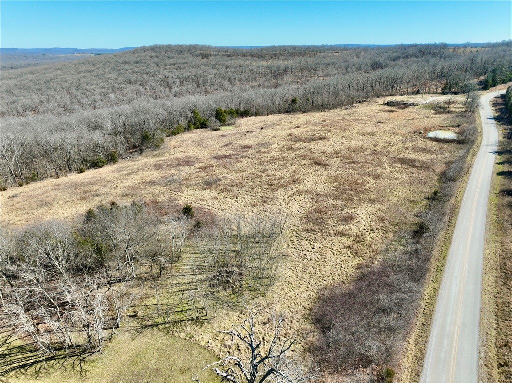 Spectacular buildable tract located minutes from Devil’s Den State Park and a short drive to Strickler, AR. This beautiful property features paved road frontage, electric on site, and rural water along the road. Enjoy breathtaking panoramic views, open pasture, large hardwood timber, and two ponds. Ideal for a dream home, hobby farm, horses, or cattle. Historic features include an old hand-dug rock well and stone fencing remnants. Excellent rural homesite and investment opportunity.