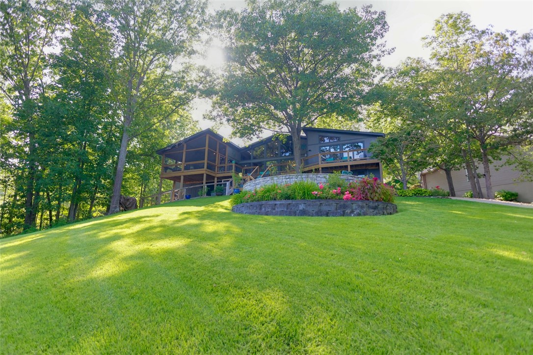 Beautiful home in Bella Vista on Lake Loch Lomond, the largest lake in Bella vista, with a marina and restaurant on the lake.  This home is a Unicorn in the area.  It was taken down to the studs and completely remodeled and updated with impeccable taste and all high end touches.  It also received all new wiring and plumbing at the time.  The main water line into the house was also replaced and sheathed to prevent any leaking.  The pictures and video describe it better than words.  
Outdoors-Massive entertaining patio with a fire pit in the center-Beautiful water fall running from the patio to the lake-Covered Dock with 5000lb boat lift and 8ft depth at dock-POA owns property on one side that will not be developed.
Indoors-Plantation shutters on the front-Marble counters in the kitchen and all baths-Pella windows thru -out with incredible views of the lake-Enclosed wine room-Screened porch-Large deck that runs the length of the back-built in shelving in closets all high end appliances. A must see and one of a kind
