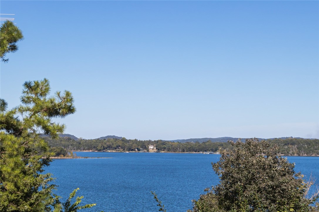Fully remodeled in 2016, this cozy 1 level lake home in the desirable Coppermine area on Beaver Lake is generating over $17,000 in net annual income. 3 bedrooms, 2 baths, large open kitchen, dining, living room with wood burning fireplace. Large back deck overlooks the oversized backyard with expansive views of the lake! No need for a boat slip or dock, the public boat ramp is just over the backyard fence at Coppermine Lodge. Hiking & biking trails nearby in Hobbs Conservation area. Come enjoy Lake Life!