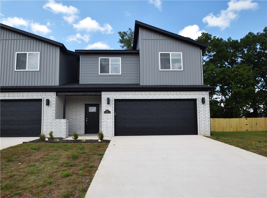 New modern design duplex in the heart of Centerton and close to Schools! Also included brand new side by side stainless refrigerator, washer and dryer. This 3 bed 2 1/2 bath plan has an open living concept with tall ceilings and tons of natural light. Kitchen has granite countertops, stainless appliances, a large pantry, and a gas range. Primary bedroom is on the main floor and has walk-in closet. Two bedrooms upstairs with full bath and landing area. Luxury vinyl plank flooring throughout the 1st floor, 2" faux wood blinds, extra storage in the upstairs attic. Property has a private back patio and wood privacy fence. Owner must approve pets and no smoking.
