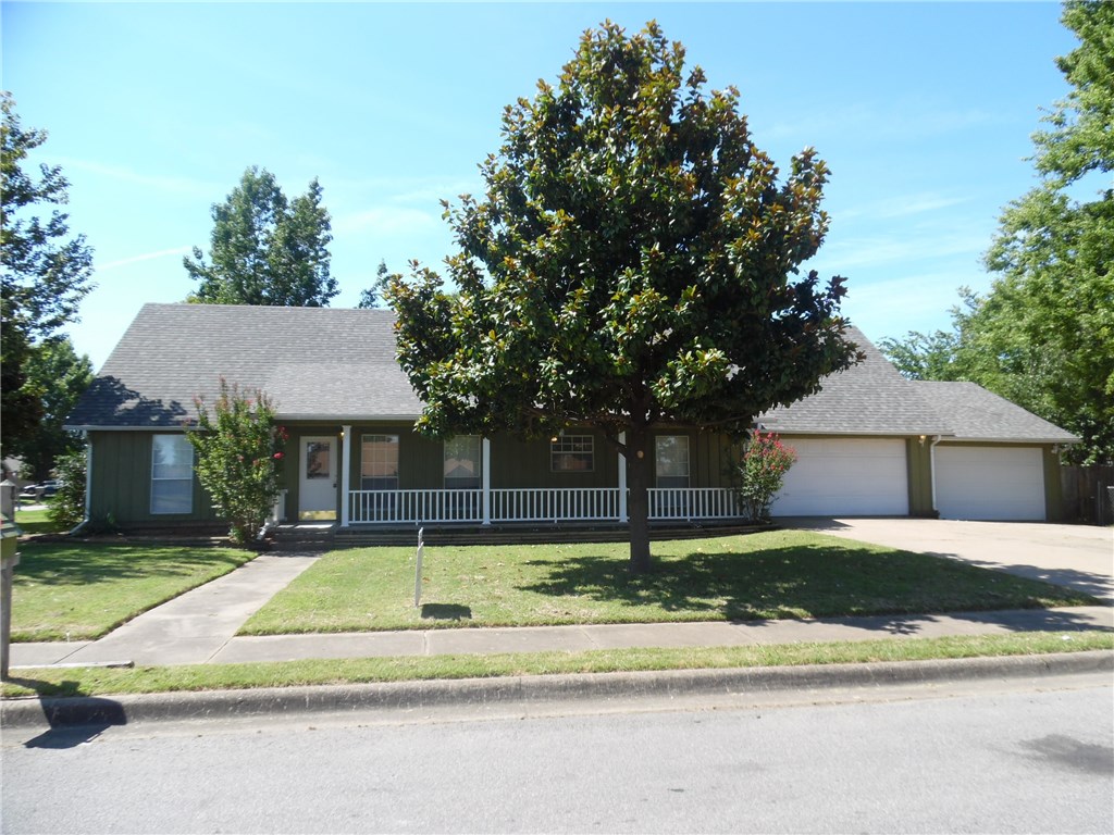Come see this charming 3 bedroom, 2 full bath home.  It rests on a corner treed lot in a super central location that is close to most everything!  Cathedral ceilings are above a raised hearth gas log fireplace.  Wood laminate flooring in living room, new carpet in bedrooms, ceramic tile in all wet areas.  3 car garage with tons of storage.  You're going to love this floorplan.