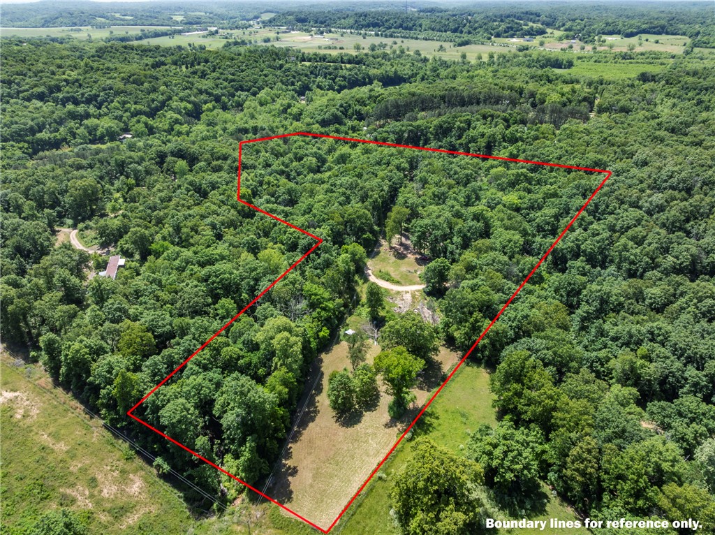 Discover the perfect blend of privacy, convenience, and potential with this beautiful 9.33 acre +/- tract. Tucked away in a quiet and secluded setting, this property offers the peaceful country feel buyers are looking for while still being just minutes from town. Featuring 3-4 excellent building sites, the land is ideal for a dream home, family compound, cabins, or investment opportunity. Electricity is already in place with meter loops for two hookups plus an additional RV electric hookup, making it ready for immediate use or future development. A huge natural spring with abundant water flow provides an excellent potential water source and adds to the property's unique character and appeal. Enjoy the tranquility, mature surroundings, and endless possibilities this versatile property has to offer.