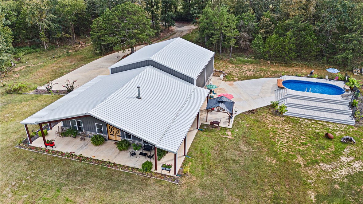 UNIQUE, RUSTIC- MEETS- INDUSTRIAL IN THIS PHENOMENAL NEWER BARNDOMINIUM! 5,600 sq ft of heated/cooled integrated living space, work place, and hobby arena. Only 3 years old, this secluded, stunning, creation sits on 40 acres more or less. Mountain views, close proximity to the national forest, mountain biking trails, and lakes. Breathtaking views, huge, covered porches on the exterior. The interior of the home portion has exquisite details in every square foot. All appliances convey. The home is approx 1900 sq. ft with the massive garage and shop hosting the remainder of 5600 sq feet. Shop has a half bath. Shop and garage have their own mini split systems. Built to withstand wind velocity of 115 mph (per seller), all windows, doors, skylights, and other covered openings were designed to withstand the specified wind loads. Every room offers high customization. The creek meanders through the north portion of this acreage.