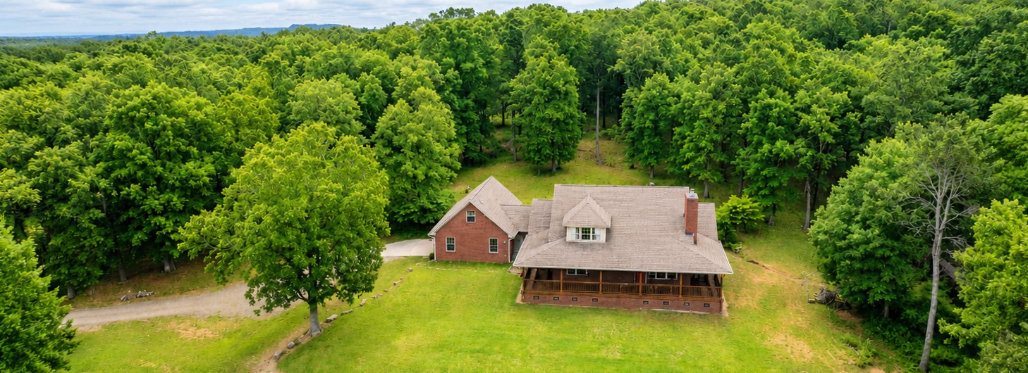 Perched on approximately 31± acres, this charming property offers breathtaking views, peaceful surroundings, and room to live the country lifestyle you've been dreaming of. Featuring 3 bedrooms, 2 full bathrooms, and a spacious bonus room above the garage, there's plenty of space for family, guests, a home office, or hobby room. Enjoy sunrises and sunsets from the inviting wrap-around porch, where the stunning scenery stretches for miles. The property also includes an outbuilding for extra storage or workshop space and a greenhouse, perfect for gardening enthusiasts or growing fresh produce year-round. Whether you're looking for a private retreat, hobby farm, or a place to simply enjoy wide-open spaces and incredible views, this property offers the perfect blend of comfort, functionality, and natural beauty, all just minutes from downtown Clarksville. Don't miss this rare opportunity to own your own slice of paradise!