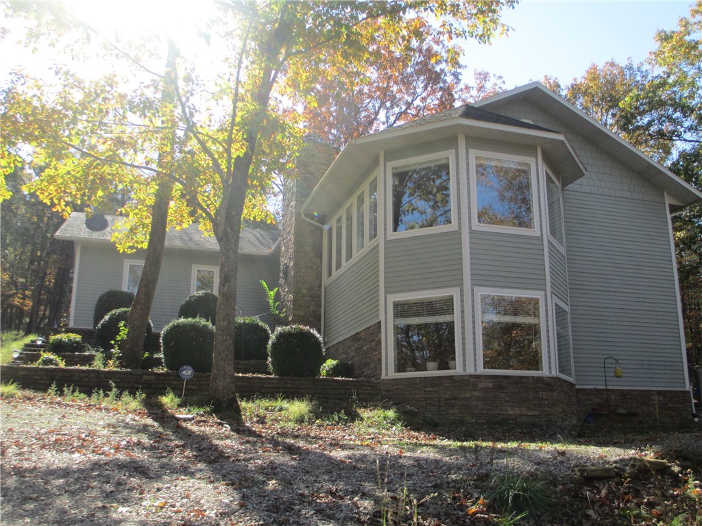 Looking for privacy, a lovely well maintained home & 1 +acre of land? Here it is! This property has it all. Wonderful light filled open living/dining/kitchen all warmed by the marble surround that graces the wood burning fireplace. The sun bounces off the custom wood cabinets in the kitchen onto the gleaming granite countertops & bar. If you prefer your morning coffee on the deck it's just a few steps away. The large primary suite includes a walk-in closet & ath w/dual vanities. 2 additional bedrooms share the hall bath. The laundry room & extra storage closet complete this level. There is a great opportunity for rental income from the lower level apartment that is only accessed from outside the home. Full bath, kitchenette & open space of the apartment can be configured to fit your needs. Oversize 2 car garage with built-in shelving & two additional storage buildings have space for all your toys & yard equipment. Wooded acreage includes a wet weather creek. Cul-de sac at end of the road maintains for privacy.