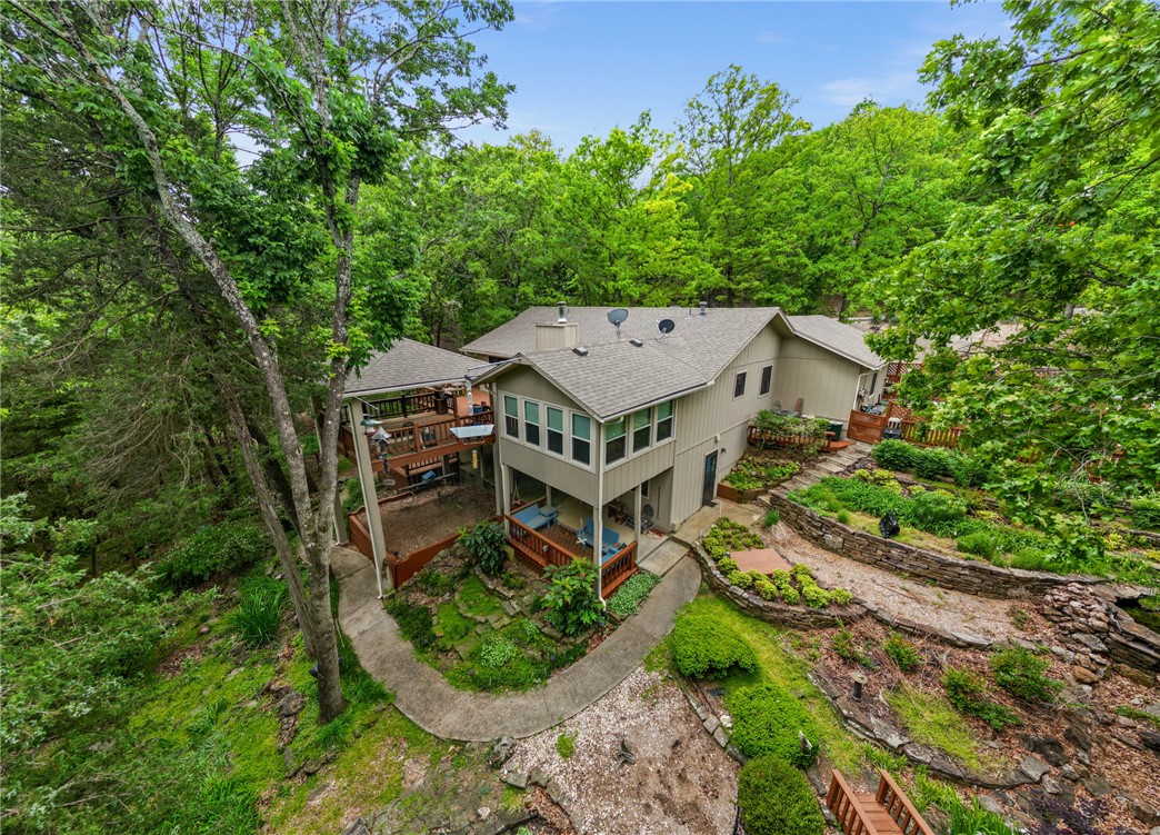 Motivated Seller!!! Experience the best of lake living in this beautifully maintained 3 bedroom, 2.5 bath lakefront home in Lost Bridge Village.  This inviting property features a 2 car garage plus a 1 car detached garage.  Enjoy outdoor living at its finest with two levels of spacious decking overlooking the natural surroundings, along with a charming gazebo ideal for entertaining.  

The home is surrounded by extensive landscaping and thoughtfully designed raised bed gardens, creating a peaceful, park like setting.  A gentle, easy walk leads you straight to the lake.  Inside and out, this home has been exceptionally well cared for, offering a move-in ready retreat.  

Located in a desirable community with amenities including a pool and pickleball court, this property combines comfort, convenience, and the ultimate lakefront lifestyle.   Whether you are looking for a full time residence or weekend escape, this Beaver Lake gem delivers!