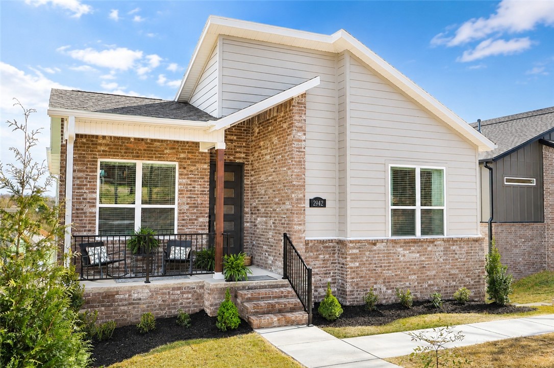 Welcome to The Kyrie at 2942 N Old Wire Rd. in Livingston, a modern new construction home by Brittenum Residential featuring 1,941 sq. ft., 3 bedrooms, 3 baths, and a 2-car garage. This thoughtfully designed floor plan offers an open main living area with a spacious great room, fireplace, dining area, and a large kitchen with ceiling-height cabinetry, island, walk-in pantry, quartz-style countertops, Frigidaire Professional appliances, gas cooktop, built-in oven and microwave, designer backsplash, and statement lighting. The main-level primary suite includes decorative stained beams, a walk-in closet, and a private bath with dual vanity and tile shower. A second bedroom and full bath on the main level add flexibility, while the lower level includes a third bedroom, full bath, laundry room, garage access, and extra crawl space/storage. Enjoy a covered front porch, covered back patio, and modern curb appeal with brick, siding, wood accents, and black details. Located close to Fayetteville parks, trails, din
