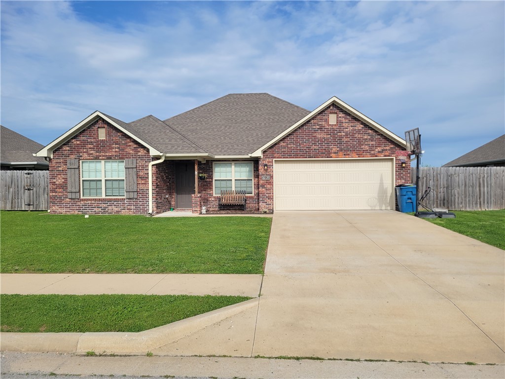 Beautiful brick home in Northwest Arkansas! This 4BR/2BA home features a desirable split floor plan and open-concept living area. Spacious living room flows into an eat-in kitchen with pantry, dark-stained cabinets, and matching flooring for a modern, elegant look. Primary suite offers privacy, while additional bedrooms provide flexibility for family, guests, or office space. Two full bathrooms. Additional features include a 2-car attached garage, ample closet/storage space, and a nice yard—perfect for outdoor enjoyment. Great location with convenient access to shopping, dining, and schools.