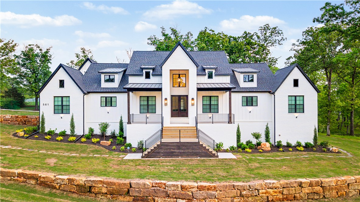 This custom built home offers everything...Come home to Shelby Forrest subdivision, NWA's new luxury getaway, large lots with lots of trees & privacy. Built on a large corner lot, this home offers an open floor plan, Taj Mahal quartzite throughout the home, a gorgeous chef's kitchen featuring a 48 inch 6 burner + griddle range & pro vent hood, 2 dishwashers, a large farmhouse sink + prep sink, a 60 inch fridge/freezer & large hidden pantry, massive primary suite with stunning walk in shower and a showstopper closet, beautiful white oak hardwood flooring throughout the home. The large upstairs bonus/media room has its own bathroom & could be a 6th bedroom. The sheer amount of closet & cabinet space will amaze you. Also features an office/5th bedroom, large laundry room and an outdoor patio space that will impress anyone. The seller just installed a 120 inch theater screen with full audio system and movie seating in the bonus room. Located just 5 minutes from downtown Rogers & 15 minutes from downtown Bentonville