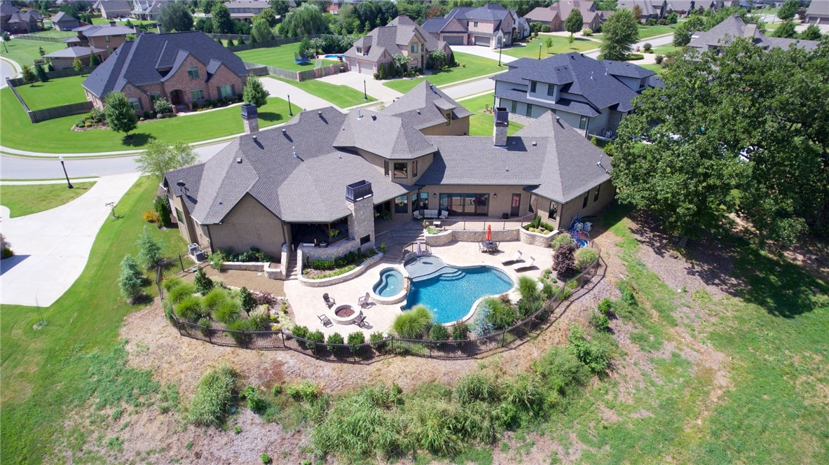 Make this resort style paradise your permanent home! Mark Melton Construction: builder's personal home packed with quality. Stunningly gorgeous, entertainer's delight! The massive gourmet kitchen, room size pantry and wine room is open to the family room with unbelievable views of the pool, attached hot tub, covered patio, cozy outdoor fireplace, and built in grill. Spacious master suite has a unique master bath and huge closet with laundry hookups. Upstairs getaway areas include a game room and media.