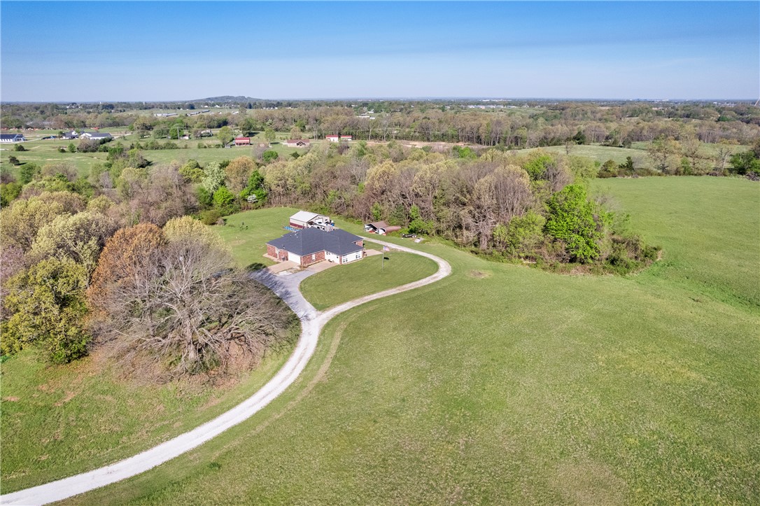 Enjoy space, privacy and functionality on 5.58 acres with this thoughtfully laid-out three-bedroom, 2-bath home. A versatile welcoming living/entertainment area provides the perfect space for movies, playtime or a retreat, flowing seamlessly into the main living room, dining area and kitchen for a functional layout that works well for both everyday life and entertaining. The primary bedroom offers a private sanctuary with its own bathroom, while two additional bedrooms are connected by a Jack-and-Jill bath, providing convenience and flexibility. Step outside to the back deck and enjoy views of the open land directly behind the home, an ideal location for a future pool or expanded outdoor oasis. An insulated shop with electricity enhances the property’s usability and offers endless possibilities. With acreage that invites expansion and a layout built for comfortable daily living, this property presents a rare opportunity to enjoy both space and practicality in a setting that’s becoming increasingly hard to find.