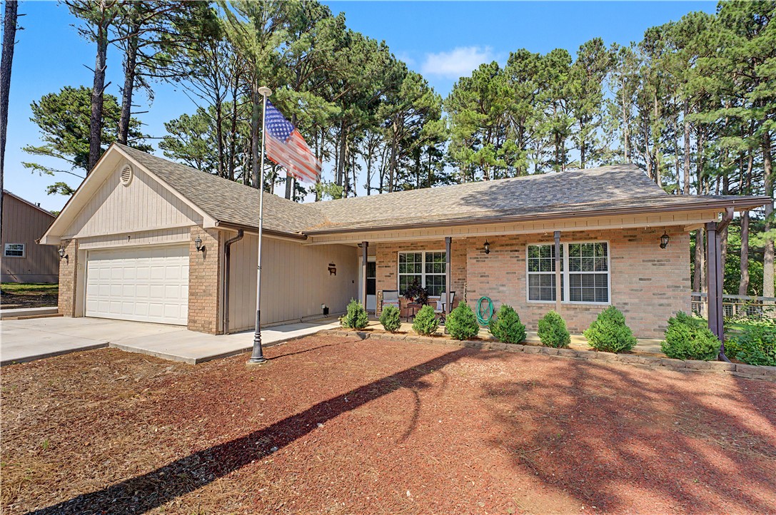 Tired of looking at the same cookie cutter homes? This 3 bedroom + Bonus room 7 Fairlie Ln has all you've been looking for. Fresh painted and a Double lot (0.80+/-) for complete privacy backing up to green space with gorgeous pine trees.   FLAT fully fenced backyard, 4 car garage- 2 being a detached garage or workshop for your hobbies including 220 V outlet.  1 level living with multiple bathrooms and bedrooms on the main floor. This home offers abundant natural light as you enter the home and draws you to the backyard through the heated and cooled sunroom. Multiple living spaces for entertaining. Many updates throughout this home including: New roof 2024, Tankless hot water heater 2025, New concrete driveway and walking path around the home, newly added covered patio perfect for grilling and entertaining, new gas stove with a recent fill of the 1000 gallon propane tank, Septic tank was pumped in 2025.