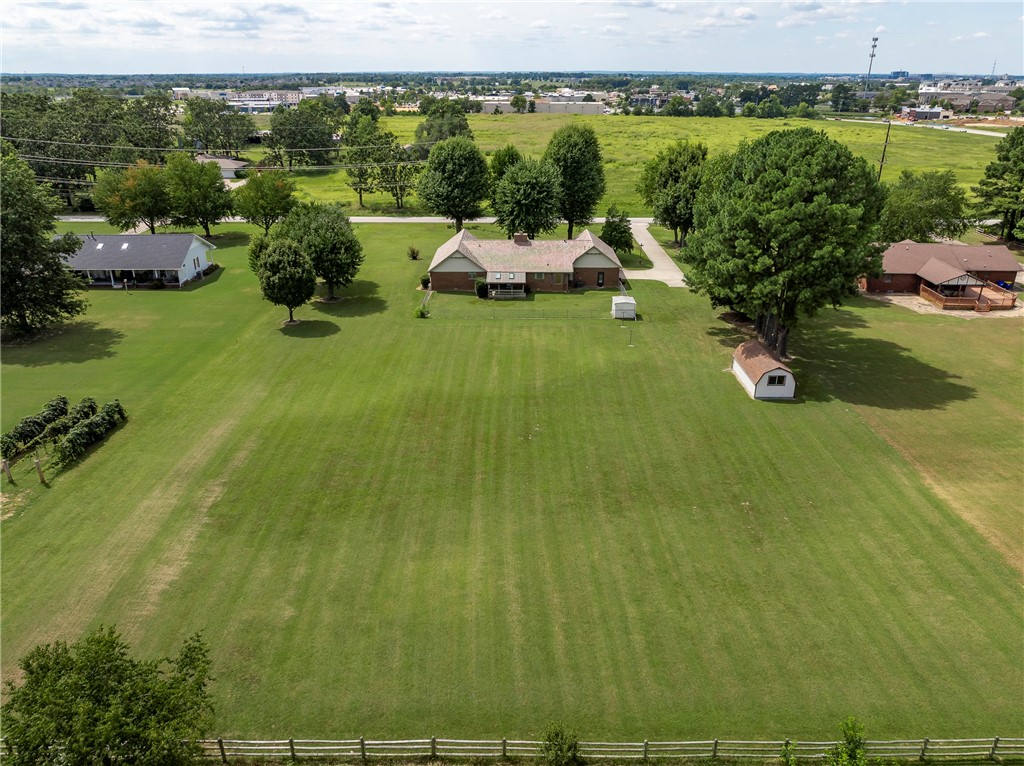 Welcome to your dream retreat on nearly 2 flat acres in a prime location—just minutes from shopping, dining, and schools! This inviting 4-bedroom, 2-bath home offers space and comfort, featuring a large living room perfect for family gatherings or cozy nights in. Step outside and discover a spacious yard, large enough for a pool, pool house, or both—giving you endless opportunities to create your own private oasis. For hobbyists or extra storage, two versatile shop buildings (one is 8x8 and one is 12x14) provide plenty of room for projects, tools, or even a small business venture. With 1.99 acres of level ground, there’s ample space to play, garden, or simply enjoy the wide-open surroundings. This rare property blends convenience, charm, and opportunity—ready to welcome its next owner home!