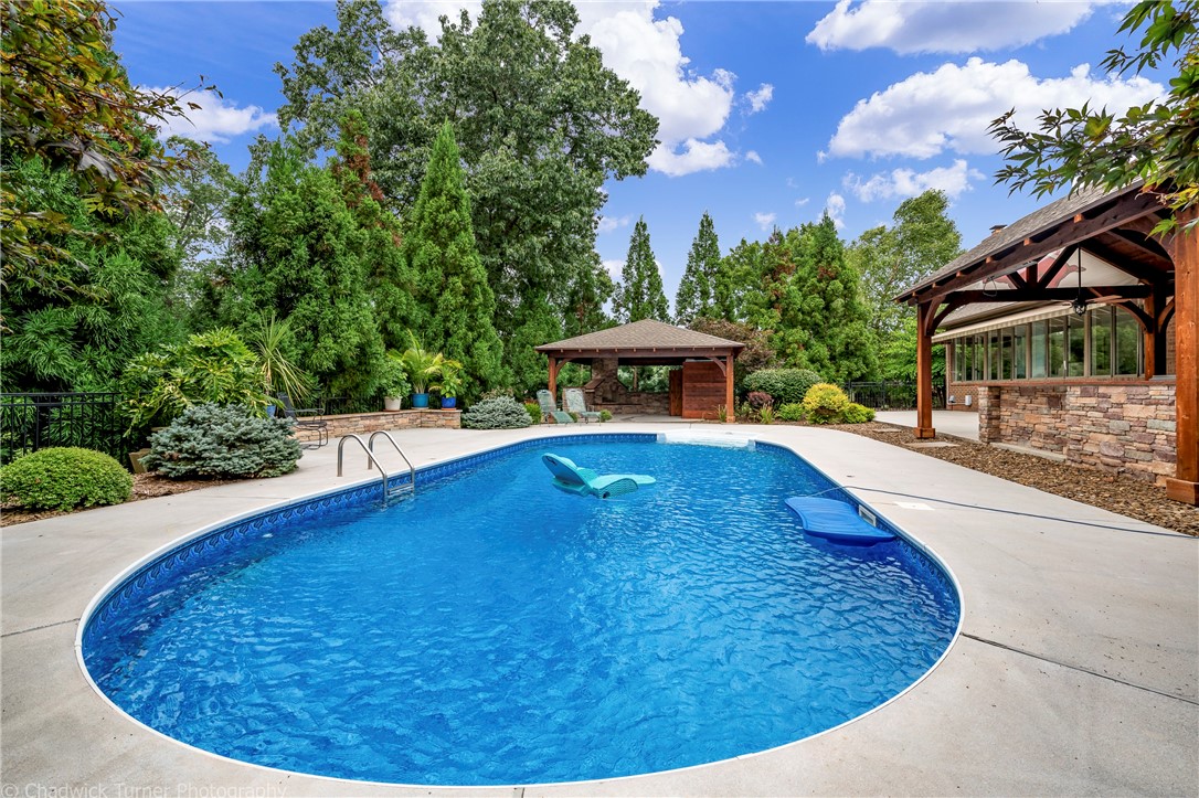 Estate property located on 4 park like acres near Pinnacle Promenade. This property features a main home with almost 6200sqft which includes 4 bedrooms 4.5 baths and 3 living areas including a game room and sun room. Out back you will find a pool and resort like outdoor space including outdoor kitchen area under cedar pergola, fireplace and outdoor bath. Then there is a private guest house which is almost 1200sqft with 1 bedroom full kitchen and an attached 1 car garage. Also on the estate you will find a 30x50 shop building with 10' tall garage door. 
Seller realizes buyers may want to remodel part of the home and price reflects that. There has been many updates to the home both cosmetic and mechanically. Please request copy of features sheet for some of those updates.