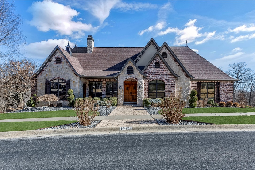 Prime location and Unparalleled style are featured in this custom-built home. Just 1 mile to Crystal Bridges, Amazeum, and the new Whole Health Institute, 2 miles to Downtown Bentonville, and 2 miles to the new fabulous Walmart Campus, this home places you in the epicenter of it all. This stunner boasts upgrades at every turn. The exterior exudes fantastic curb appeal.  Double decks offer wooded view perfect for relaxation or entertaining. Step inside and be captivated. From the impressive home office, gourmet kitchen with two islands, three fireplaces, finished game room, wet bar, custom cabinetry, and a primary bathroom boasting nine shower-heads and heated flooring, this smart home has it all. Downstairs showcases a world of entertainment and relaxation. This home offers not just a living space but an experience. With proximity to cultural everything, this home is an invitation to embrace a life of comfort, style, and endless enjoyment.