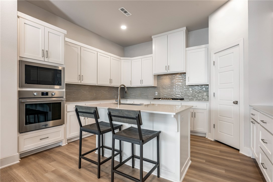 It's not just about location, it's about convenience and flexibility.   Easy travel = 15 minutes to XNA airport.  Home layout is perfect for remote work with the community high speed giga byte built in so working from home couldn't be easier.  Being close to everything NWA has to offer with easy commute to Wal Mart corporate campus or Mercy Hospital. The common area next door means no one can ever build there. The landscaped common areas have abundant decorative lighting. Aurora's amenities: 2 pools (1 adults-only), pickleball, open-air clubhouse, walking trails, a dog park, and picnic areas designed for real outdoor living. This is one will surely steal your heart!