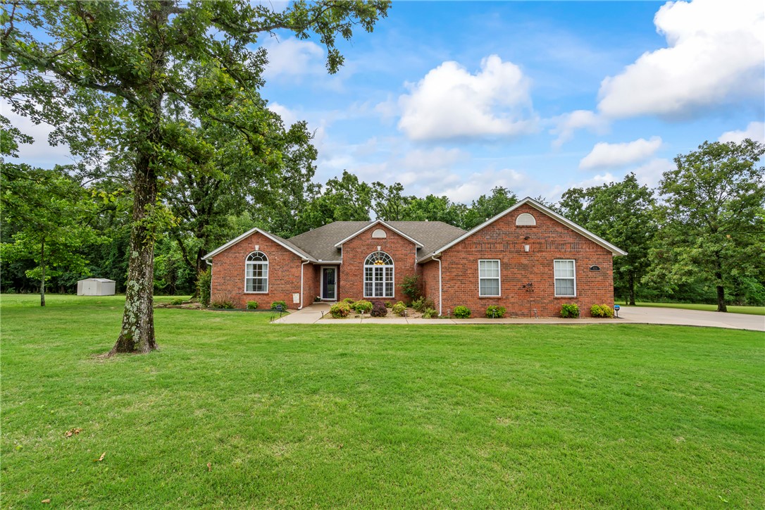 4 Bed, 2 Bath home with a den on .65 acre lot that backs up to woods for added privacy! Built in 2004, this well-maintained home features two living areas, cozy gas log fireplace in living room, granite counters, LED lighting, crown molding, cathedral & trey ceilings in several rooms, pantry, arched doorways, decorative architectural touches, eat-in kitchen & formal dining. Recent updates include new roof (2019), remodeled interior with fresh paint & granite throughout (2019), gas instant hot water heater (2024) & LVP flooring with carpet updates (2016). Spacious primary suite features double sinks & walk-in closet. Front bedroom features a beautiful arched window & cathedral ceiling for added character. Enjoy the fenced backyard with a covered patio & freshly painted pergola & fencing, perfect for relaxing or entertaining. Additional features include covered front porch with beautiful landscaping, storage building, three storm doors, central vac system, outdoor Christmas light plugs with dedicated garage switch.