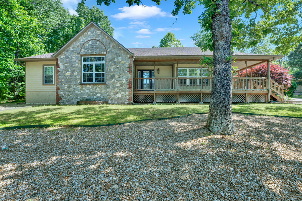 Lovely, *well maintained* one level home with wrap around covered deck and side-entry garage. Roof is less than 1 year old with impact shingles. New alarm system and Nest thermostat convey to buyer. Wired for surround sound. LVP flooring throughout shared areas. Large living room with gas fireplace. Formal dining. Eat in kitchen with cabinet storage galore. Refrigerator is newer and will convey. Double vanities in both full baths. Good sized utility room with sink. Handicap accessible doorways. Low maintenance yard and long lasting Hardie-Plank & Stone Exterior siding. Septic pumped in 2025. Very private backyard. Just down the road from Branchwood Rec Center and Nature Trail. Agents see MLS attachments for Home Warranty and Roof details.