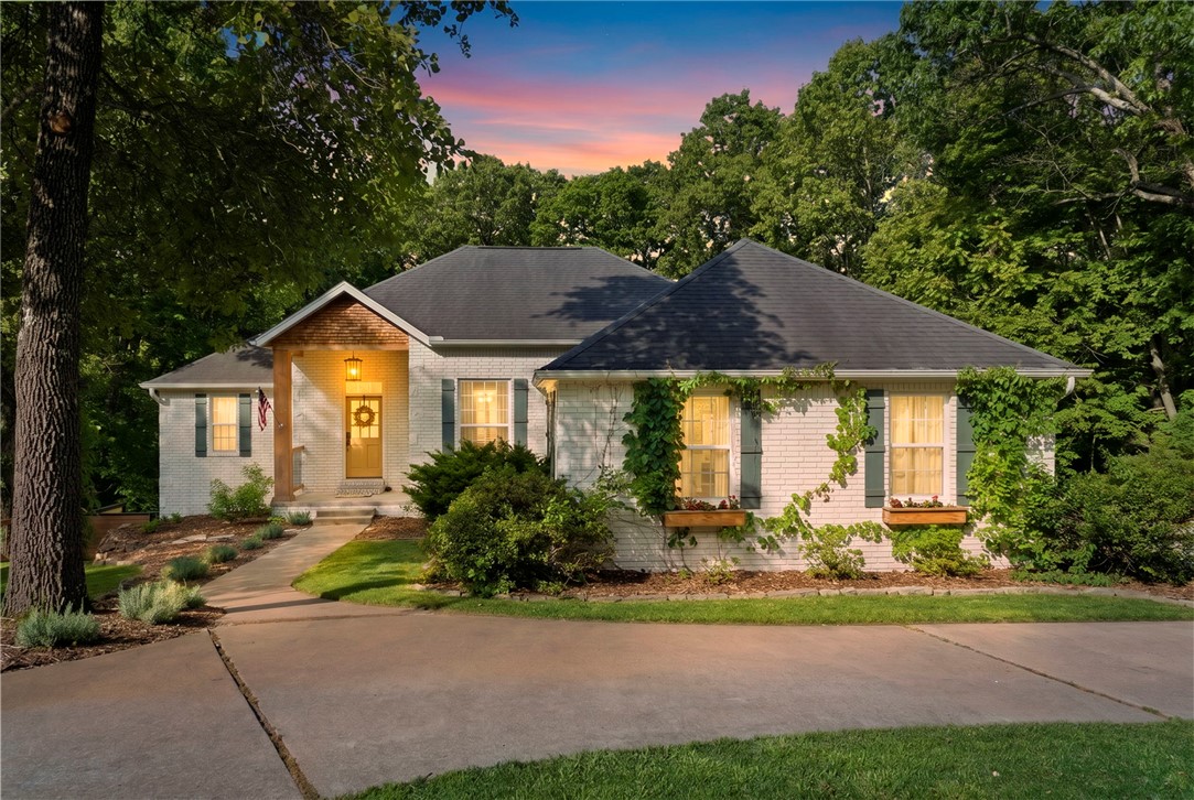 Price Improvement and seller offering up to $5000 in seller credits. Fully renovated and move-in ready, this exceptional 5.1-acre property offers a beautifully updated 3-bed, 3-bath home plus an income-producing cabin and 24x36 pole shed/shop. Located just 10 minutes from the Walmart Home Office and downtown Bentonville, it combines privacy and convenience. The main home features new flooring, updated baths, a remodeled kitchen with new appliances, and a dedicated movie room. Major systems include a 3-year-old water heater and HVAC units under 2 years old. Enjoy an above-ground pool with new liner, large deck, and screened outdoor living space with TV, fireplace, and kitchen. The 500 sq ft cabin is a successful Airbnb with full kitchen, bath, loft, separate utilities, and its own septic. Additional septic stub and 100-amp service allow for future expansion, guest quarters, or added rental income potential. Airbnb cabin can remain under existing management with ownership change, generating immediate monthly income.