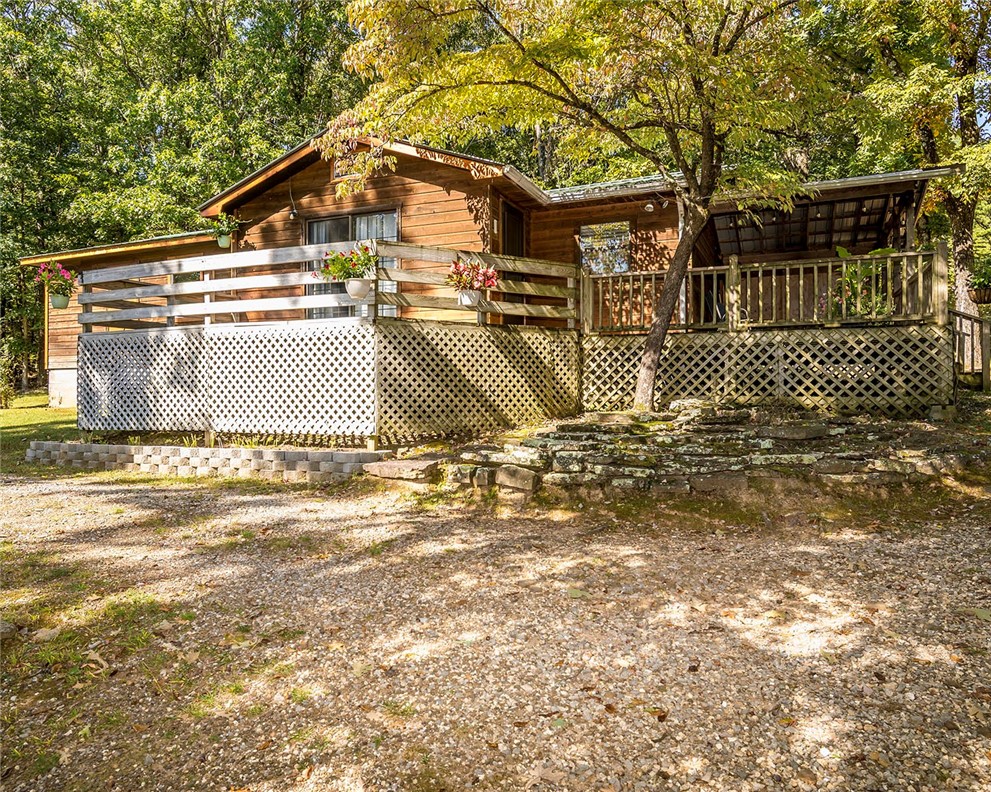 Looking for a well-maintained, private paradise in the Ozarks? This 20+ acre parcel has been owned and well maintained by the same owners for over 40 years - come and check it out! Extremely nice 3 BR home, plus a fantastic metal shop with 900 SF under roof. Add in a beautiful 16x28 inground salt-water pool, a 10x14 storage building, metal roofs on all three buildings, and lots more! Brand new HVAC system in August 2025, new septic system in January 2021 (pumped in August 2025), a new pool liner and kitchen cabinets in 2022, fenced garden spot, and you have your own oasis in the country! Come & see!