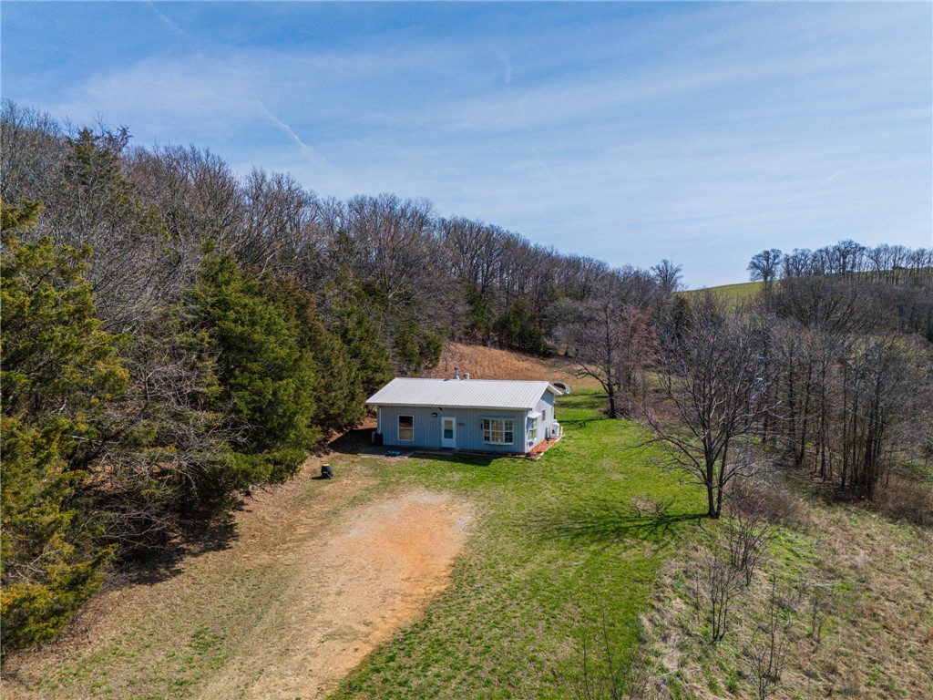 Fully remodeled 2-bedroom, 1-bath home on 7.44 acres in the scenic hills of Carroll County just outside Berryville. This property offers the peaceful setting many buyers are searching for, along with beautiful long-range views toward Eureka Springs. A serine setting awaits you everyday after a full workday!  The home has been thoughtfully updated and is move-in ready, making it ideal as a full-time residence, weekend retreat, or investment property in the Ozarks. The surrounding acreage provides space to enjoy the outdoors, garden, or simply take in the natural beauty of the area. A large workshop adds exceptional versatility for hobbies, equipment storage, or workspace needs. With 7.44 acres of land, scenic views, and a fully remodeled home, this property offers the opportunity to enjoy the quiet lifestyle of Northwest Arkansas while remaining a short drive to Berryville, Eureka Springs, Branson, Harrison and area amenities.