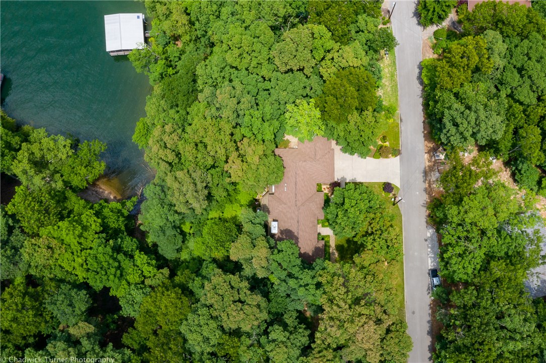 Immaculate Custom Built One Owner Lakefront home on beautiful Beaver Lake featuring 4BRs/3 full BA & multiple living areas with amazing views. Direct access to the lake just steps from your back door where you can enjoy the lake & wildlife. Enjoy outdoor dining on one of 2 decks overlooking the lake from your spacious kitchen. Amenities include gorgeous hardwood flrs, beautiful master suite on main flr, huge laundry rm. Entertain downstairs with a wet bar. Downstairs features 2nd living area, 2 Br's & a full BA. Would make excellent mother-in-law quarters. This home allows privacy for all your family & guests! Tons of storage. New roof in 2015. New HVAC 2014, House Generator. Large 3 car garage with built-in workshop. Professionally landscaped grounds with irrigation system. Custom built outdoor storage shed. All appliances convey. This Pristine home sits on a 1/2 acre lot on quiet cul-de-sac. Walk your canoe or kayak to the shore for an afternoon of fun in the sun.