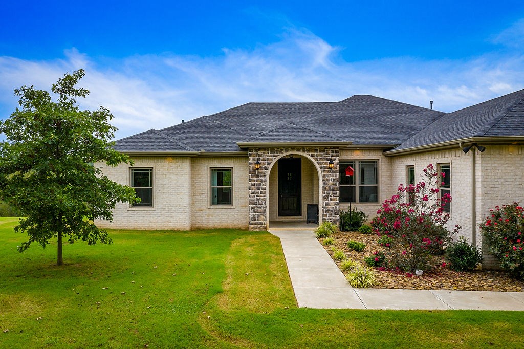 Enjoy quiet country living close to town with this absolutely gorgeous home on 2 1/2 acres. This stunning one level home offers peaceful and picturesque views, split floor plan, large open living area with a propane gas fireplace and vaulted ceiling, 3 spacious bedrooms, 2 1/2 bathrooms and an office with French doors. The open kitchen features a gas cooktop, granite countertops, center island, and stainless steel appliances. Eat-In Kitchen has large window to the amazing views outside. Huge Master has walk-in shower, soaking tub, double vanity, and walk-in closet that connects to the utility room. Additional bedrooms share a Jack and Jill bath.  Entertain on your covered back patio or sit by the propane fireplace and take in the mountain scenery. Welcome home to this custom built house conveniently located on the West side of Fayetteville!