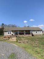 COUNTRY SETTING  Looking for something in the country and want peace and quiet.  You have to come see this 4 BR 2 BA home situated on 15 acres with its on barn and chicken pens.  Upon entering the security gate and winding down the long driveway you will be delighted once you arrive at this beautiful home in the country.  As you pull up you will notice the great front porch for entertaining or spending time sitting drinking coffee.  Once inside you can  read a book in one of 2 living areas next to the fireplace or  relax in the jacuzzi tub.