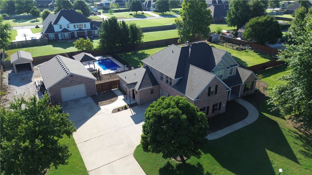 Set on a full acre, this beautiful home is designed for both everyday living and entertaining.  The main level features a spacious primary suite, dedicated office, and a newly added 276 sq. ft. utility room with dog bath and extra half bath. The kitchen boasts newer appliances including double oven, microwave, and gas cooktop. Upstairs includes a private media room and additional bedrooms. Outside, enjoy a backyard retreat with a brand-new pool liner, cool decking, and fresh professional landscaping. Additional features include an attached 3-car garage, 40x25 insulated shop, 24x12 storage shed, in-ground storm shelter, new roof in 2021 with transferable 20-year warranty from Brown Boys Roofing, plus 2nd level HVAC in 2017.  A rare blend of comfort, function, and outdoor living—move-in ready and easy to show!