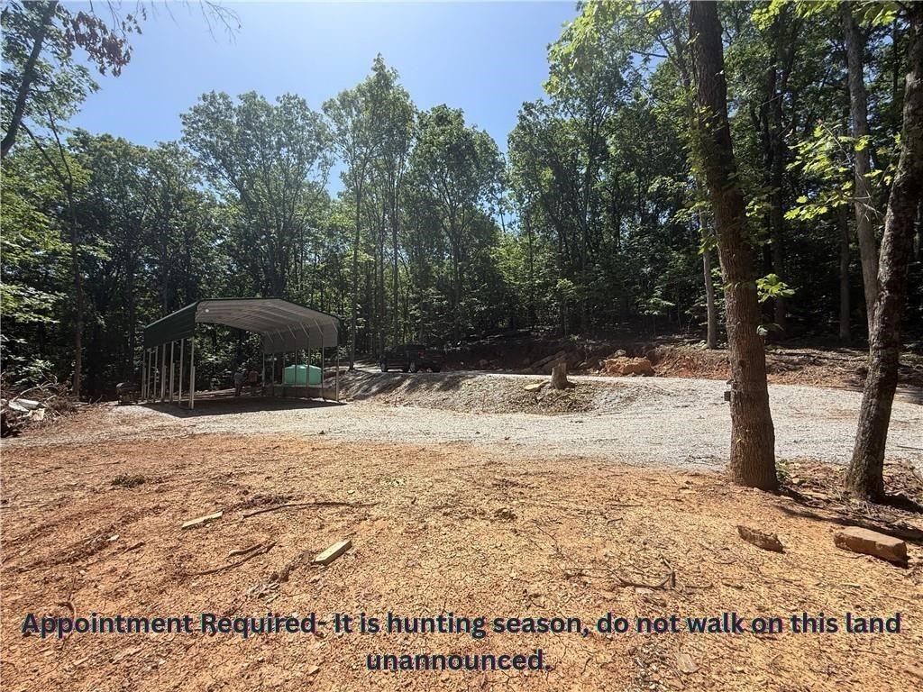 This is the spot to be! - Apt Required- unrestricted nearly 8 acres, developed with all utilities, AND private access to shared 22 acres of White River Access. Located in the mountain community of River Meadows. Move your camper right into the 20x30x12 awning that has cement footings and all of your utiltiy hookups. The septic is professionally installed and less than 1 year old. It has two hooks ups ready and three additional options for expansion. There is a water tank on site and ready to be plumbed into your camper/cabin. Fiber is available at the site by Ozark Go. 200amp power is run to the awning with 100amp servicing a 30 amp outlet, over head lighting, and several ground fault outlets. There has been extensive ground work to create roads and mulitiple building pads/parking areas. The property has a cave, waterfall, and seasonal creek that runs most of the year. Deer, bear, and turkeys are often on the property. Just a short drive down M5114 you can access the private 22 acres to swim, kayak, or trail ride.