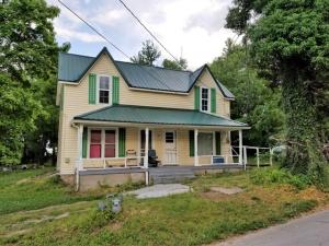 Two story home with some remodeling; newer metal roof and mainly new windows; end of street location; close to school; home needs some finish work; nice newer shop building with concrete floor and electricity