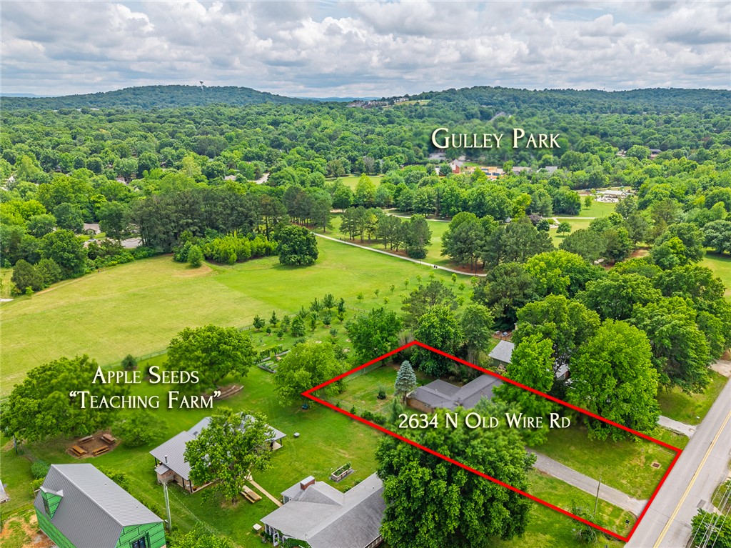 This beautifully renovated home offers direct easement access to Gulley Park. Enjoy the biking trails, splash pad & Summer Concert Series right from your backyard! Every major system has been replaced, including the roof (2020), HVAC (2024), hot water heater (2025), and new gutters (2025). Real hardwood floors, updated kitchen & bathrooms, and a sunroom with energy-efficient windows + crawl space encapsulation completed in (2025). Large, private yard, minutes to downtown Fayetteville, the Square, U of A, and interstate access, all within the Butterfield Elementary district!